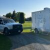BlueJay Rentals truck dropping off washroom trailer outside worksite