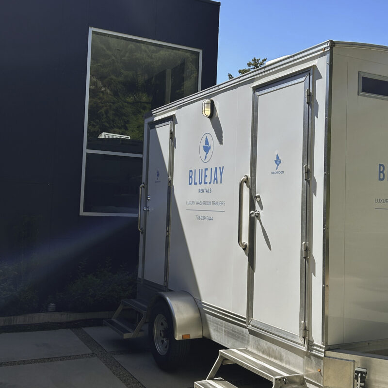portable washroom trailer parked outside house